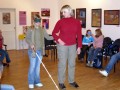 Cvičitelka ukazuje, jak správně nabídnout nevidomému pomoc...